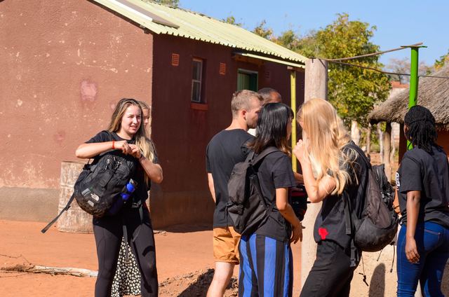 Volunteers standing near a village water point